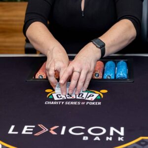 Person shuffling card at a poker table