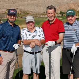 Four golfers pose for a photo