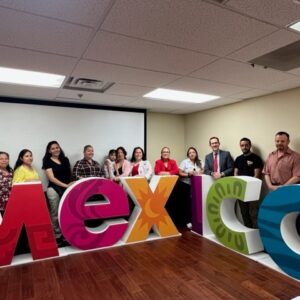 People standing behind sign that says Mexico