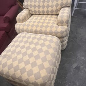 Beige and light brown diamond-patterned armchair with matching ottoman on a concrete floor.