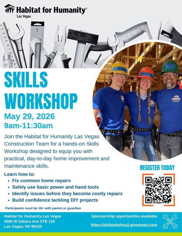 Three people in hard hats and Habitat shirts stand smiling in front of a wall of tools at a skills workshop.