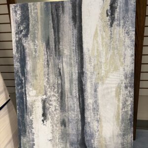 Large abstract painting with vertical streaks in muted blue, gray, beige, and white tones, set on a floor.