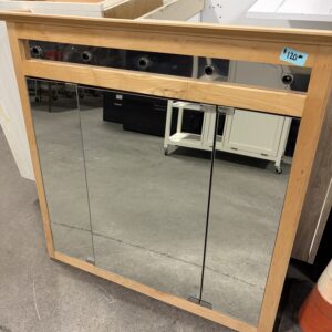 Wood-framed mirrored medicine cabinet with three doors, priced at $120, sitting on a concrete floor.