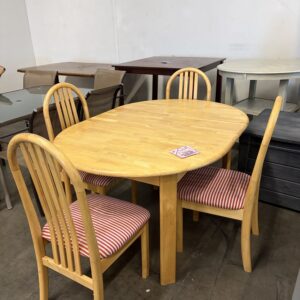 Wooden dining table with four matching chairs, each with red and white striped cushions, indoors.